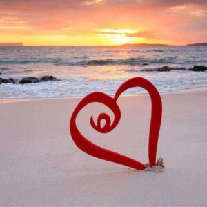 Beach sunset with a red heart standing up