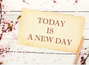 Today is a new day - on a white wooden slat background with little flowers in the corner