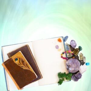 Green bakground with a journal, crystals and healing tools