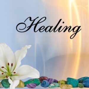 Healing a white flower blooms next a pile of colorful gemstones