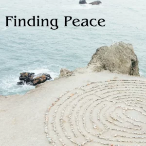 Finding peace on a background of a stone labyrinth on the sand by the ocean