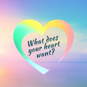A pastel background in shades of blue, pin and purple. On it, a rainbow colored heart with the words, ' What does your heart want" inside it.